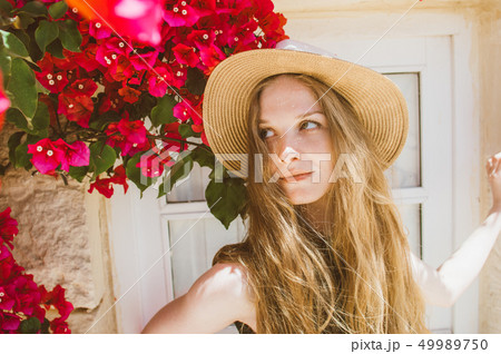 Portrait of smiling girl with tangled hair Portrait of smiling girl with tangled hair 49989750