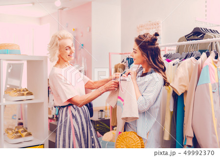 Woman choosing new t-shirt together with her mother 49992370