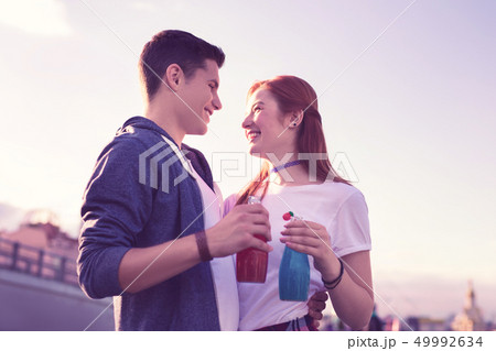 Cheerful excited young couple expressing their feelings to each other 49992634