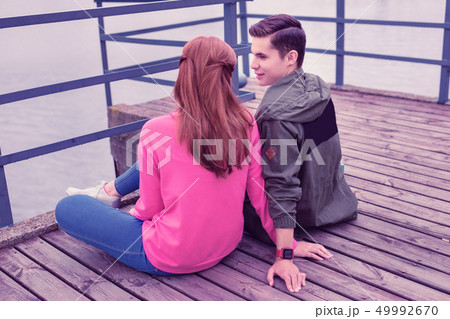Romantic dark-haired guy lovely looking on his ginger girl 49992670