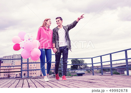 Active young man pointing with his hand while explaining 49992678