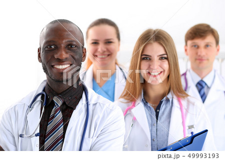 Group of smiling friendly medicine doctors look in camera Group of smiling friendly medicine doctors look in camera 49993193