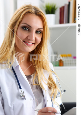 Beautiful smiling female doctor hold clipboard pad Beautiful smiling female doctor hold clipboard pad 49993267