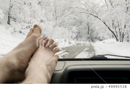 bare human feet on the panel of the car bare human feet on the panel of the car 49995538
