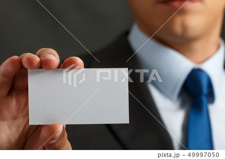 Businessman in suit and hand holding blank calling card Businessman in suit and hand holding blank calling card 49997050