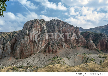 Picturesque red cliffs in front of the monastery 49997422