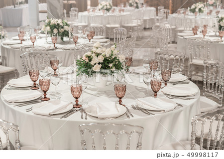 Round Banquet table served. Interior of restaurant for wedding dinner, ready for guests. Decorated 49998117