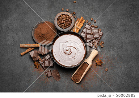 ceramic bowl of chocolate cream or melted chocolate and pieces of chocolate isolated on dark ceramic bowl of chocolate cream or melted chocolate and pieces of chocolate isolated on dark 50002985