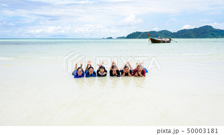 Happy family lying together on the beach, Thailand 50003181