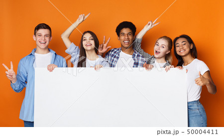 Happy friends holding empty banner, orange background 50004411