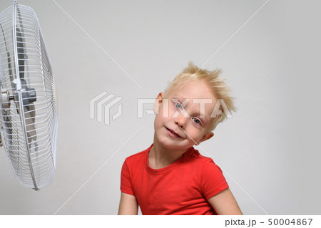 Pretty blond boy in red shirt enjoying the cool 50004867