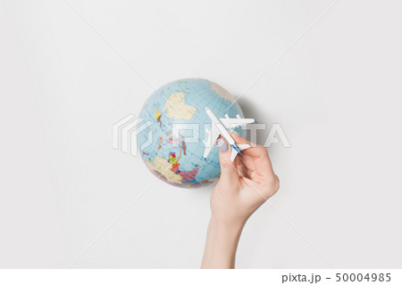 Passenger plane in a female hand on the background 50004985