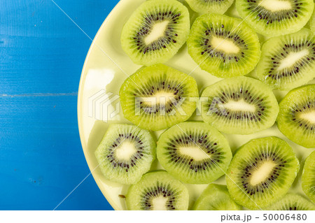Sliced Kiwi Fruit On The Plate With Blue Table Background 50006480