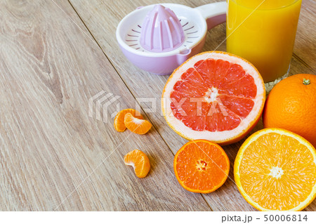 various citrus fruits, reamer and juice 50006814