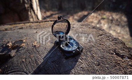 The theme is tourism and technology. Close-up navigation compass black magnetic needle lying on a 50007871