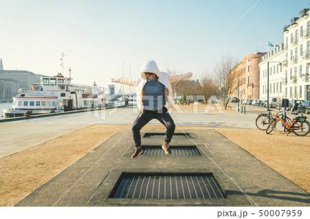 adult person rejoices like child. Playground trampoline in ground, children trampoline, springs 50007959