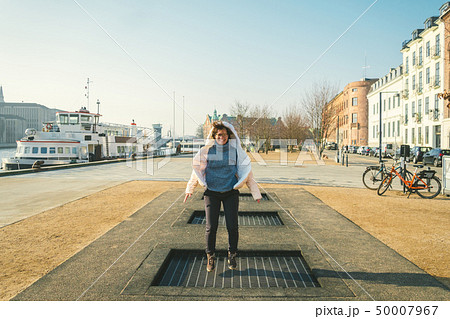 adult person rejoices like child. Playground trampoline in ground, children trampoline, springs 50007967