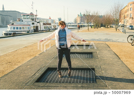 adult person rejoices like child. Playground trampoline in ground, children trampoline, springs 50007969