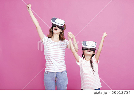 Mother and child playing together with virtual Mother and child playing together with virtual 50012754