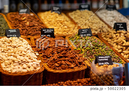 Heap of nuts and sunflower seeds, pistachio and dried fruits in bags 50022305