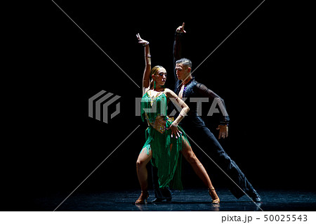Couple of dancers performing on isolated black background Couple of dancers performing on isolated black background 50025543