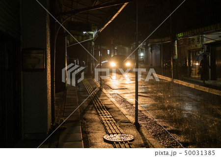 雨の夜道を走る車 50031385