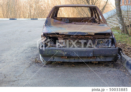 Abandoned burned passenger car near the apartment 50033885