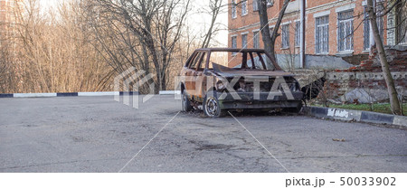 Abandoned burned passenger car near the apartment 50033902