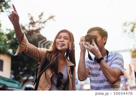 Young Asian travelers taking photo of city 50034476