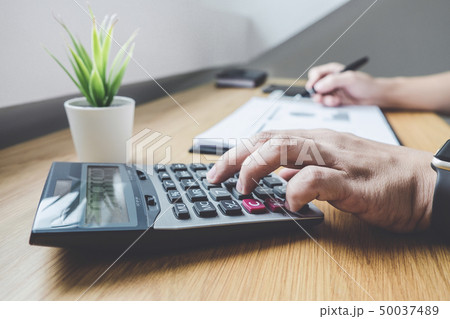 Businessman working on a graph document financial 50037489
