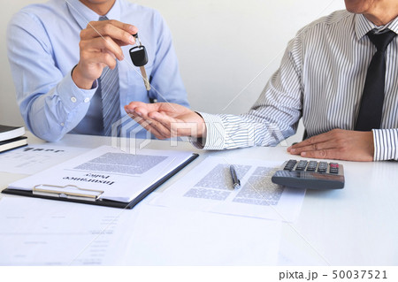 Real estate Sales manager giving keys to customer 50037521