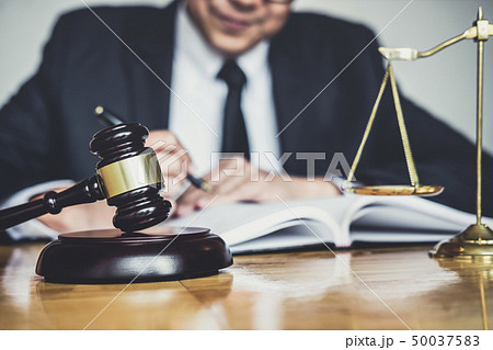 Male lawyer or judge working with contract papers, Male lawyer or judge working with contract papers, 50037583