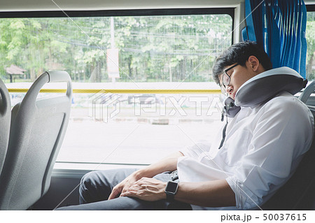 Young Asian man traveler sitting on a bus and Young Asian man traveler sitting on a bus and 50037615