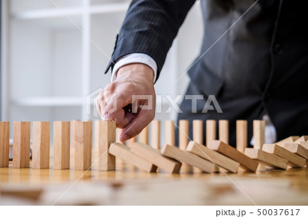 Wooden game strategy, Businessman hand stopping Wooden game strategy, Businessman hand stopping 50037617