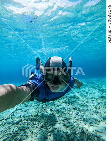 Freediver young man taking selfie portrait underwater 50038176