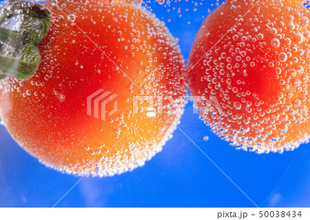 ripe tomato in water close-up 50038434