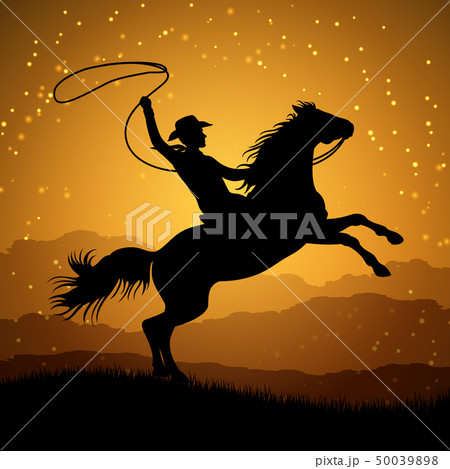 Silhouette of cowboy with lasso on rearing horse 50039898