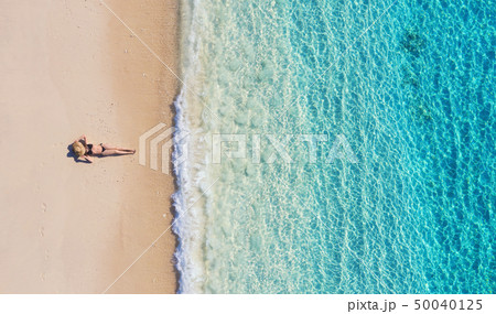 Aerial view of a girl on the beach on Indonesia 50040125