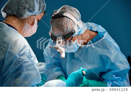 Doctor and assistant nurse operating for rescue patient from dangerous emergency case. Hospital and Doctor and assistant nurse operating for rescue patient from dangerous emergency case. Hospital and 50041129