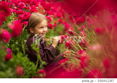 cute girl in field of wildflowers in the open air. The girl in the buttercup 50041287