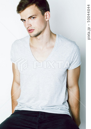 young handsome teenage hipster guy posing emotional, happy smiling against white background isolated 50044844