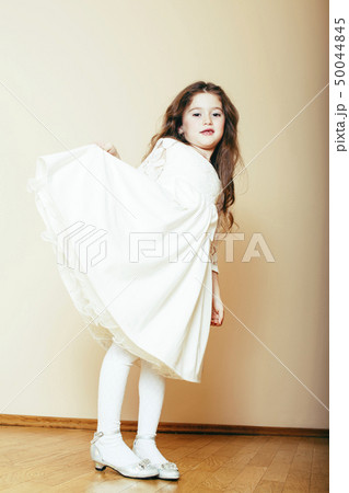 little cute girl with long curly hair posing cheerful on white background, lifestyle people concept little cute girl with long curly hair posing cheerful on white background, lifestyle people concept 50044845