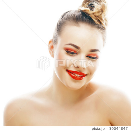 young blond woman with bright make up smiling pointing gesturing emotional isolated like doll lashes 50044847