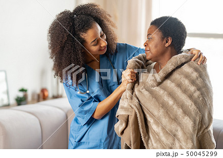 Aged lady feeling thankful to caring nurse in the nursing house Aged lady feeling thankful to caring nurse in the nursing house 50045299