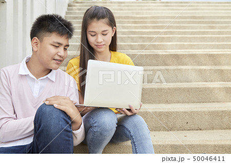 Teenage students work school job on laptop 50046411