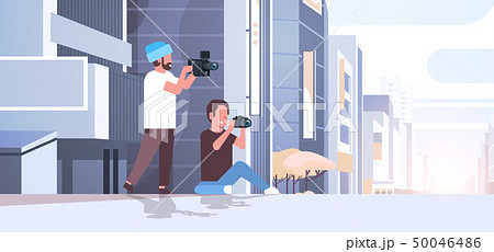 photographer and cameraman using cameras shooting video taking pictures working together over modern 50046486