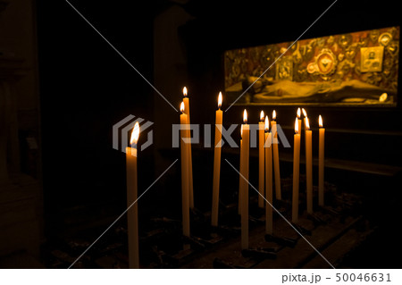 Prayer candles burning in front of grave, tomb with Jesus in Chiesa di San Zaccaria, Venice 50046631