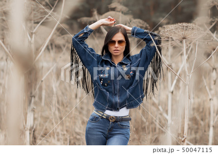Portrait of a girl in jeans in the field 50047115