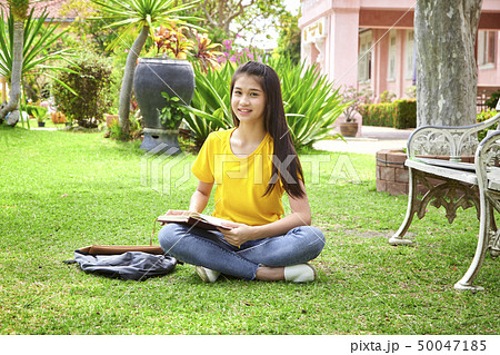 student girl reading a book in park student girl reading a book in park 50047185