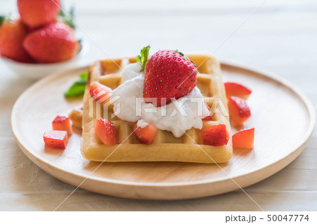 waffle with strawberry on wood waffle with strawberry on wood 50047774
